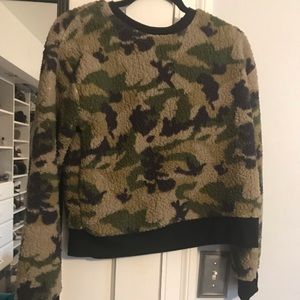 A cropped camouflage fluffy sweater
